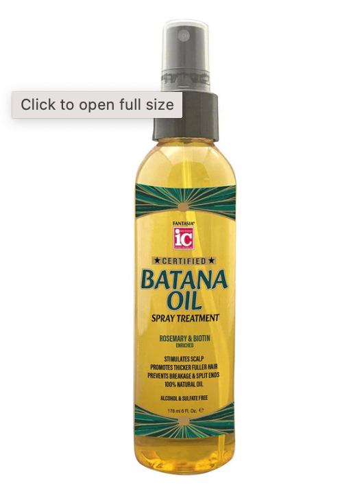Batana oil spray treatment being applied to damaged curly hair for repair and moisture