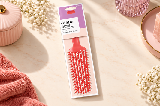 Diane Coral Flexible Vent Brush DBB020 in its lilac and white packaging on an ivory surface