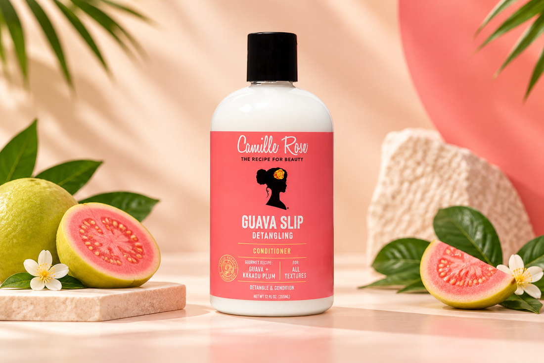 Camille Rose Guava Slip Detangling Conditioner bottle with guava fruit on a cream and coral background