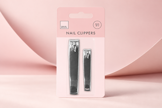 Forever Beautiful pack of two nail clippers in pink retail packaging on a blush studio background