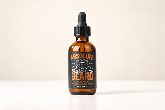 Absolute New York Sandalwood Beard Oil amber dropper bottle on a pale studio background