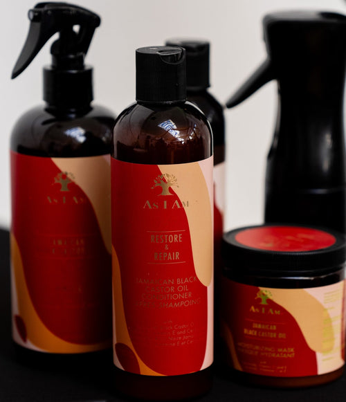 Hair care bottles and a jar with red labels displayed on a table.