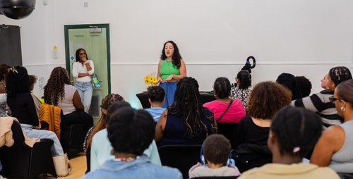 Presenter addressing seated attendees at a community workshop.