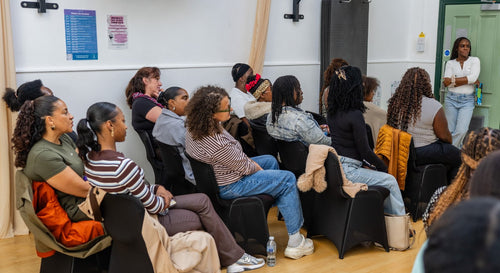 Attendees seated in rows during a community workshop.