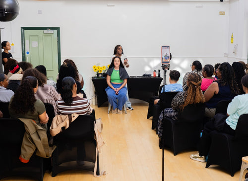 Wide view of a presenter addressing workshop attendees.