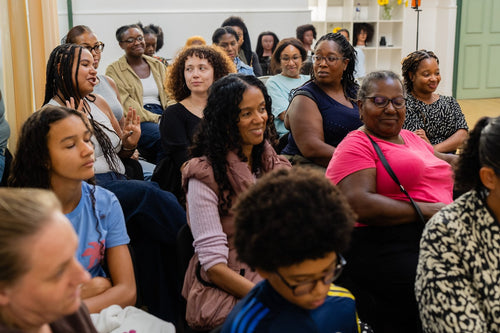 Attendees smiling during a community workshop.