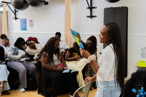 Presenter leading an activity with seated workshop participants.