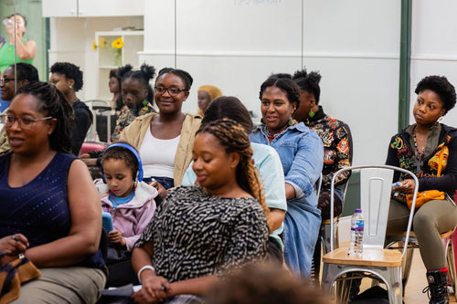 Attendees listening during a group workshop activity.