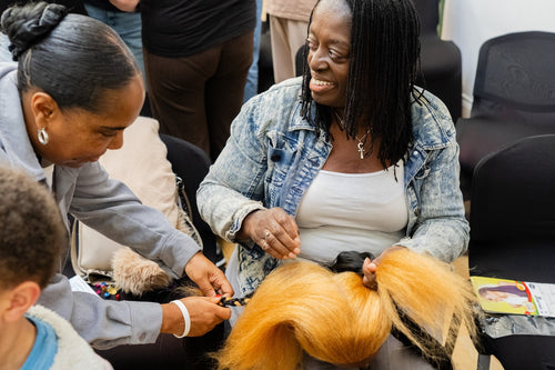 Participants working with a blonde styling mannequin.