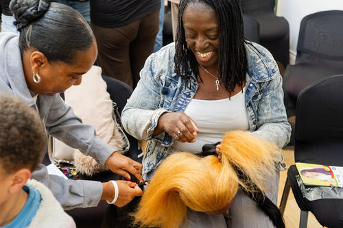 Hands-on styling activity with a blonde mannequin head.