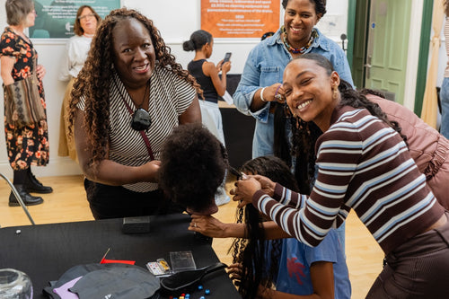 Participants gathered around a table for a styling activity.